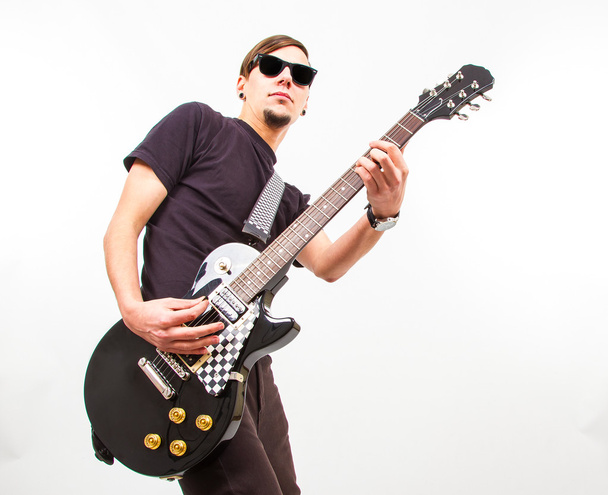 young rockstar playing on guitar  - Фото, изображение