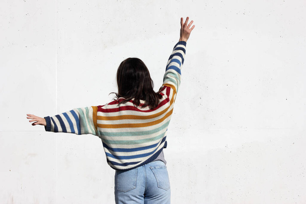 Girl in colored sweater on a white background - Фото, зображення