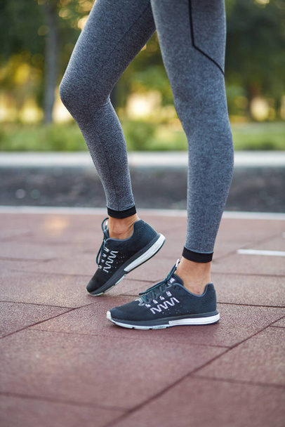 Αθλητής κορίτσι πόδια shod σε αθλητικά παπούτσια. - Φωτογραφία, εικόνα