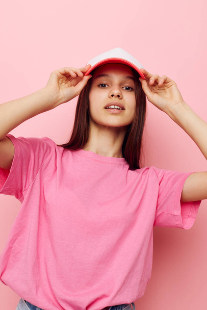 cheerful young girl with a cap on her head in a pink t-shirt - Φωτογραφία, εικόνα