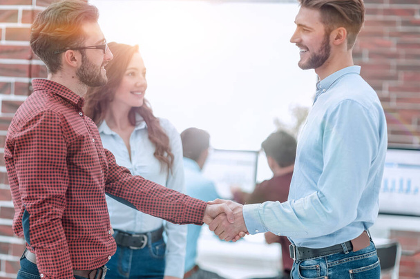 Closeup image of business partners making handshake in an office - Фото, изображение