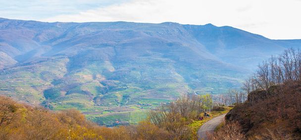Jerte Valley φαίνεται από Nogaleas ravine track, Caceres, Extremadura, Ισπανία. Χειμερινή σκηνή με hickers που αναπαύονται δίπλα στο δρόμο - Φωτογραφία, εικόνα