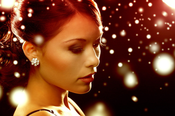 woman in evening dress wearing diamond earrings - Φωτογραφία, εικόνα