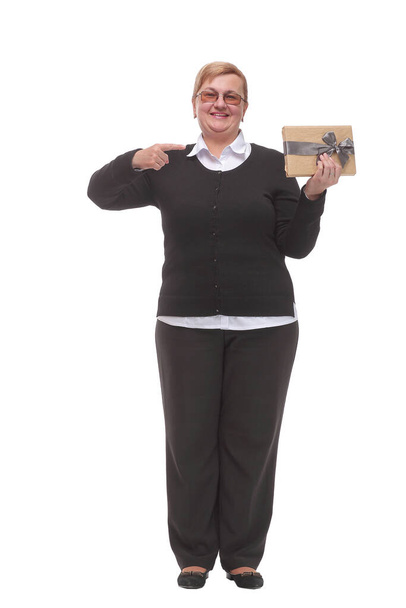 Senior caucasian woman holding gift over isolated background very happy pointing with hand and finger - Photo, Image