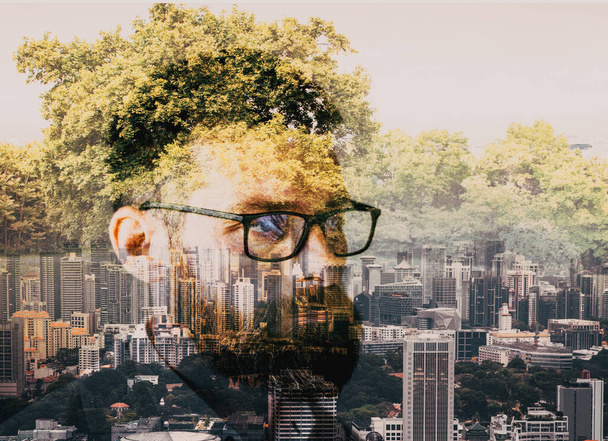double exposure of businessman head  skyscrapers and trees  escape from the city to nature - Фото, зображення