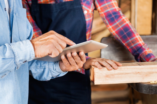 Male And Female Carpenters Using Digital Tablet - Photo, Image