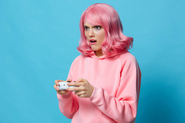 portrait woman with gamepad pink sweatshirt entertainment Lifestyle fashion - Foto, Imagen