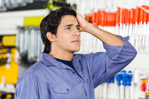 Confused Customer Looking Away In Hardware Shop - Foto, Imagem