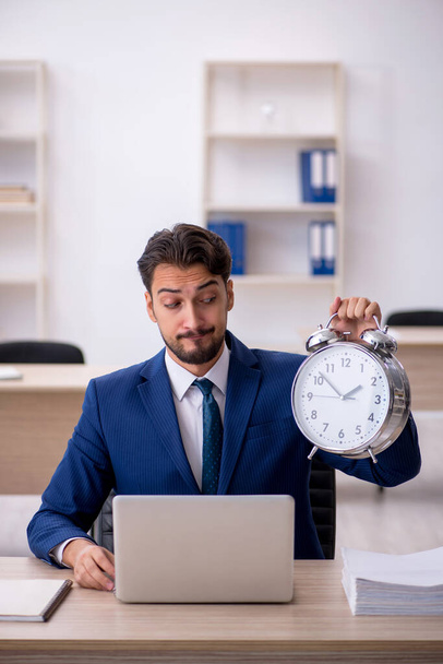 Young male employee in time management concept - Φωτογραφία, εικόνα