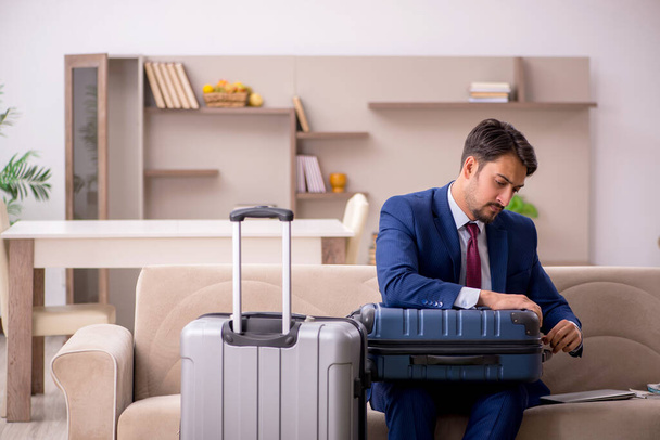 Young businessman preparing for trip at home - Photo, Image