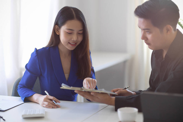 Elegant female business client discussing with sale officer, choosing some package on brochure. Insurance broker and client concept - Photo, Image