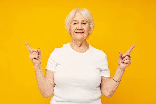 smiling elderly woman in white t-shirt posing fun isolated background - Foto, Bild