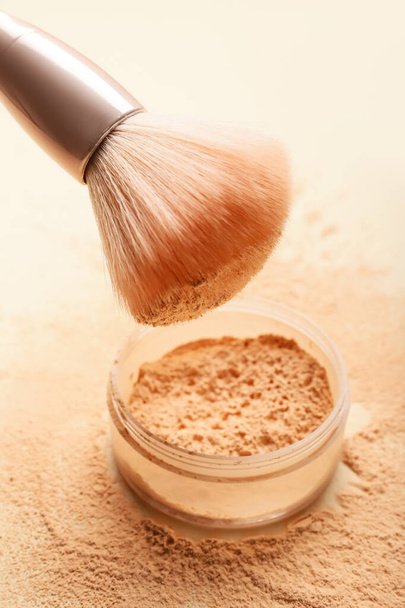 Makeup brush and loose powder on light background - Photo, Image