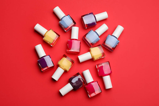 Set of nail polish bottles on color background - Фото, зображення