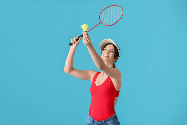 Sporty female badminton player on color background - Photo, Image