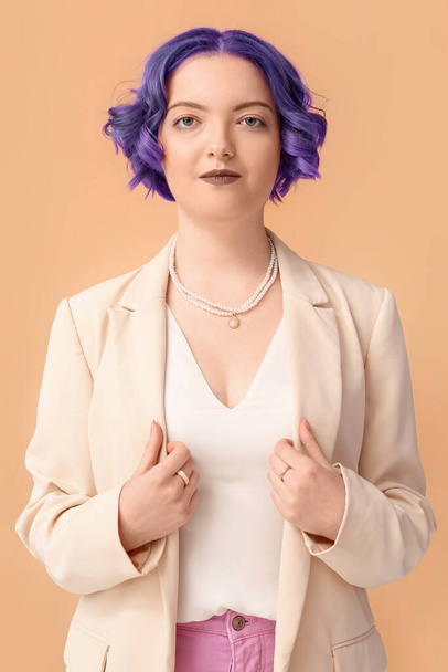 Beautiful young woman with violet hair on color background. Very Peri - color of year 2022 - Фото, зображення