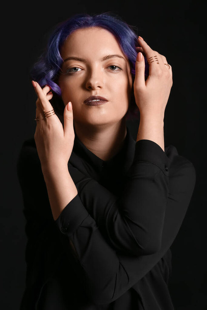 Beautiful young woman with violet hair on black background. Very Peri - color of year 2022 - Foto, imagen