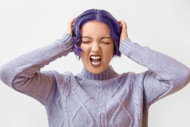 Stressed young woman with violet hair on white background. Very Peri - color of year 2022 - Valokuva, kuva