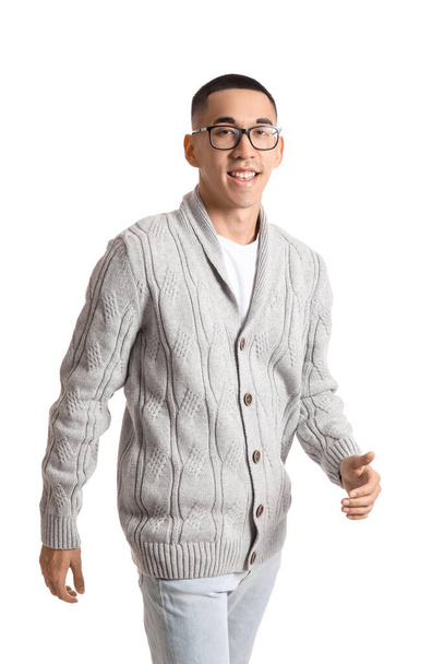 Handsome Asian man in knitted sweater on white background - Valokuva, kuva