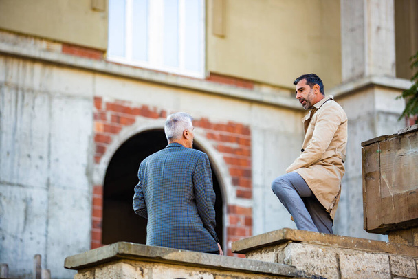 Two amazing senior businessmen are discussing something - Fotó, kép