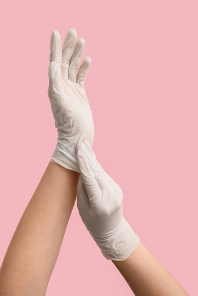 Woman in white medical gloves on pink background - Photo, Image