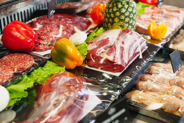 Fresh raw good quality meat on counter in Butcher shop - Fotó, kép