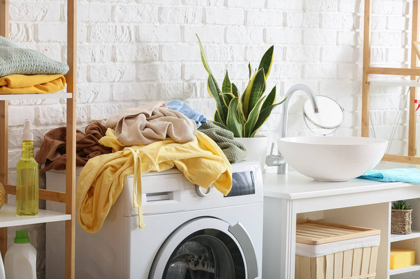 Dirty clothes on washing machine in laundry room - Photo, Image
