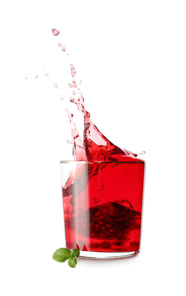 Glass of tasty pomegranate juice with splashes on white background - Φωτογραφία, εικόνα