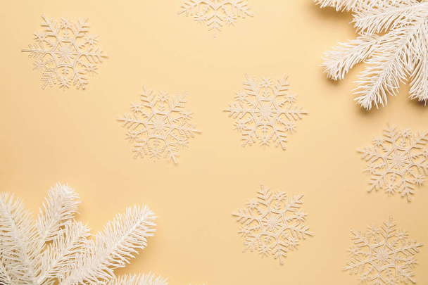 Composition with snowflakes and fir branches on yellow background - Photo, Image