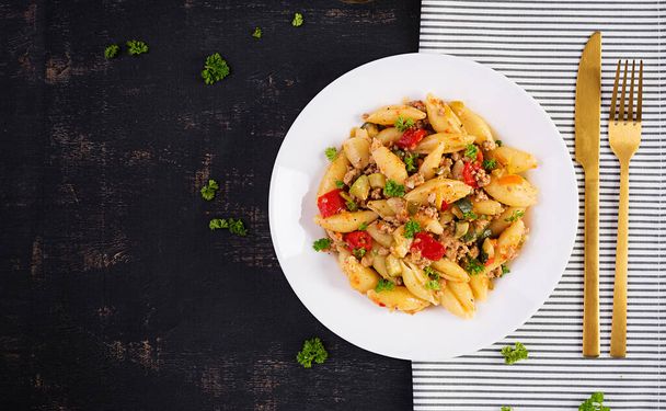 Conchiglie pasta. Italian pasta shells with minced meat, zucchini, tomato and sweet peppers. Top view, above - Photo, Image