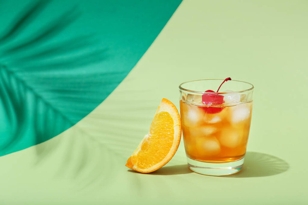 Glass of delicious Old Fashioned Cocktail on color background - Photo, Image
