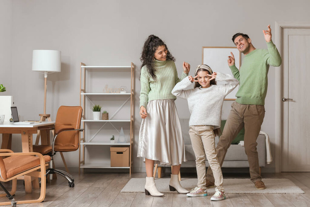 Happy family in warm sweaters dancing at home - Foto, imagen