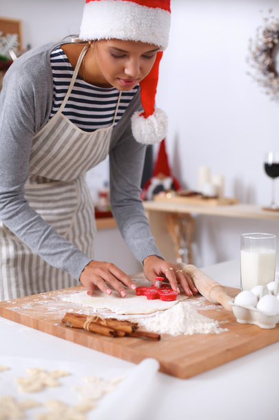 Woman making christmas cookies in the kitchen - 写真・画像