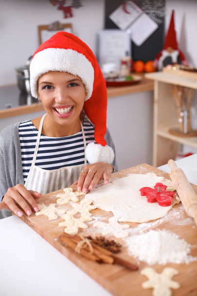 Woman making christmas cookies in the kitchen - Photo, image
