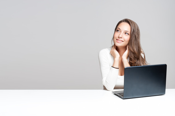 Brunette beauty with her laptop. - Фото, изображение