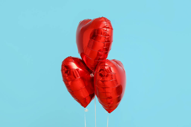 Beautiful heart-shaped balloons for Valentine's Day celebration on blue background - Photo, Image