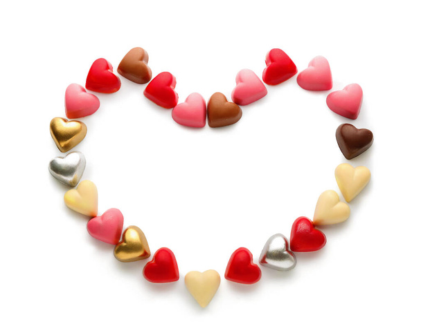 Heart made of chocolate candies on white background - Foto, Imagen