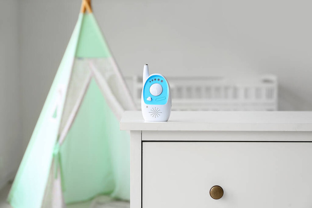 Baby monitor on chest of drawers in light room - Fotó, kép