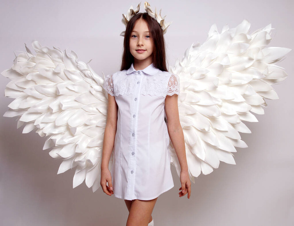 Pretty young lady with angel wings.Isolated studio shot - Foto, imagen