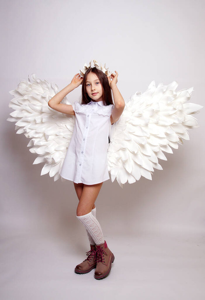 Pretty young lady with angel wings.Isolated studio shot - Foto, Imagen