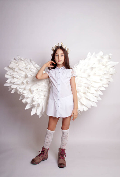 Pretty young lady with angel wings.Isolated studio shot - Φωτογραφία, εικόνα