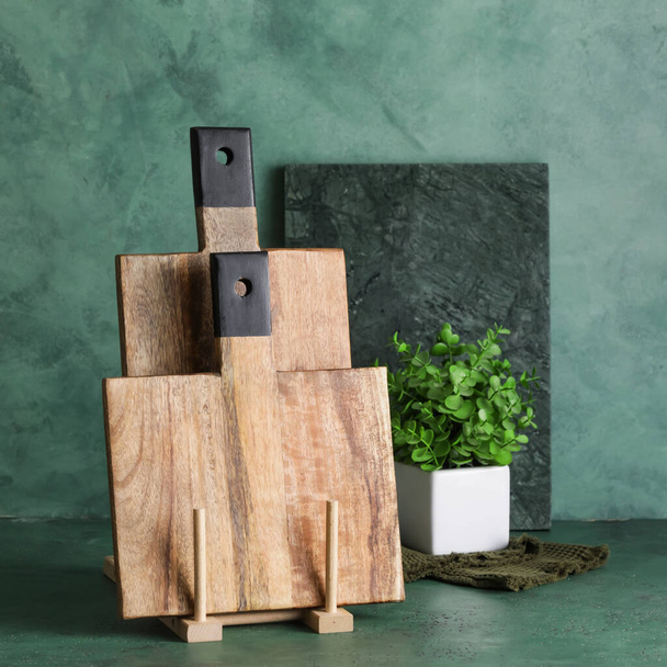 Cutting boards and houseplant on table - Photo, Image