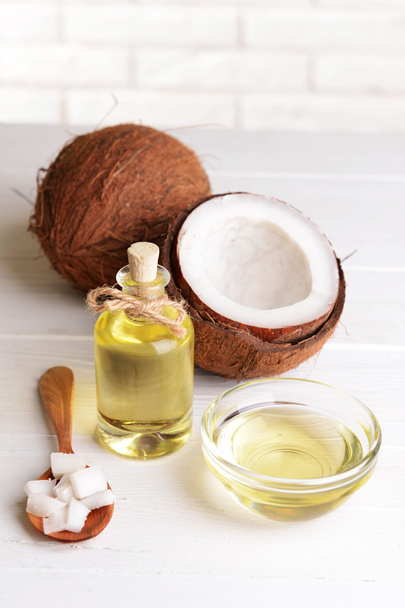 Coconut oil on table on light background - Фото, изображение