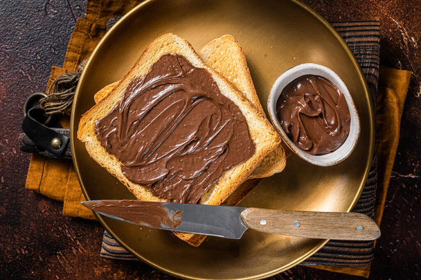 Stack of Toasts with chocolate Hazelnut cream in plate. Dark background. Top view - Fotoğraf, Görsel
