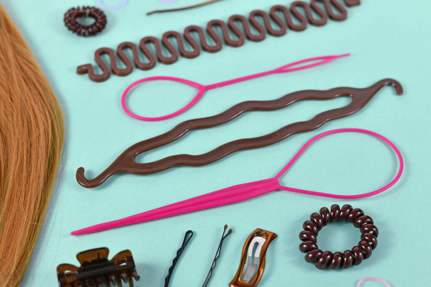Various hair styling tools like bun maker, braid tool, ponytail style maker, hair clip, rubber bands and pins  - Valokuva, kuva