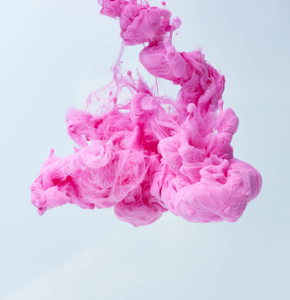 Pink splash of paint over light blue background - Foto, imagen