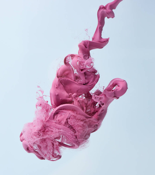 Pink drop in water over gray background - Foto, Imagem