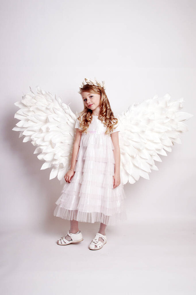 Pretty young lady with angel wings.Isolated studio shot - Fotó, kép