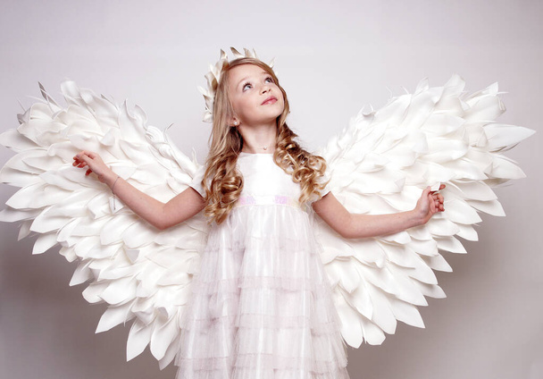 Pretty young lady with angel wings.Isolated studio shot - Foto, imagen