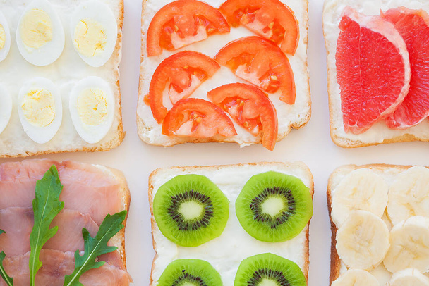 bright mix sandwiches for breakfast fruit, vegetables, fish - Photo, image